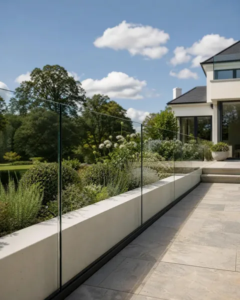 Frameless glass balustrade with a discreet dark base channel